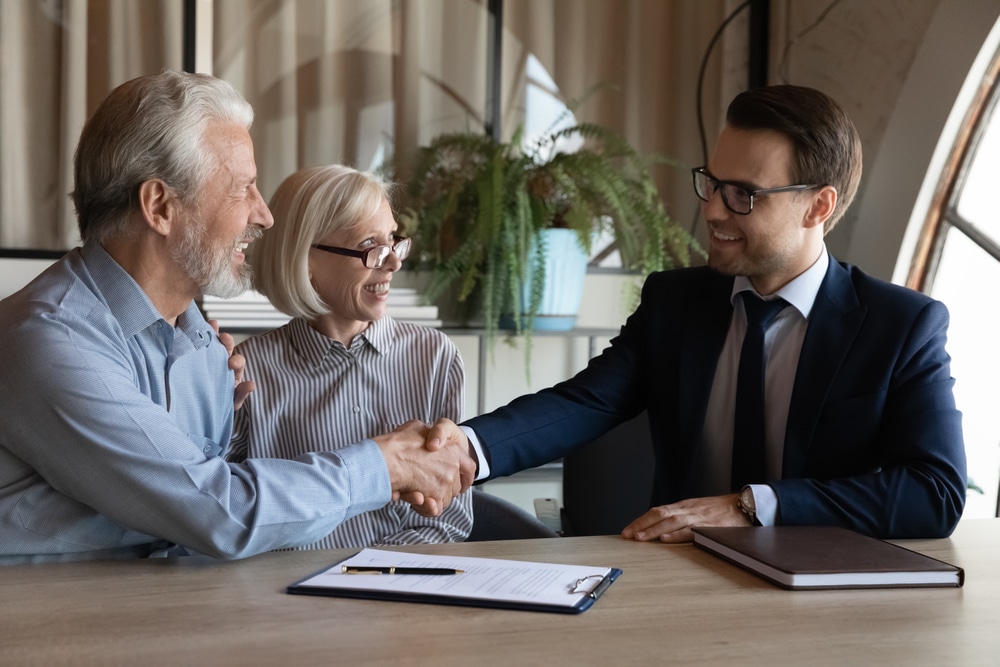 Happy,Elderly,Married,Couple,Shaking,Hands,With,Realtor,,Agent,,Notary,